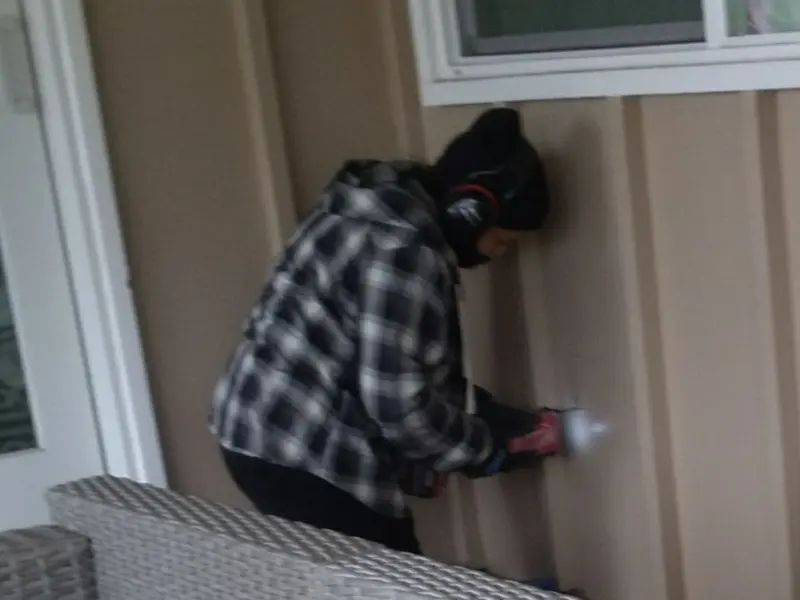 Professional electrician installing an exterior outlet in Hurricane